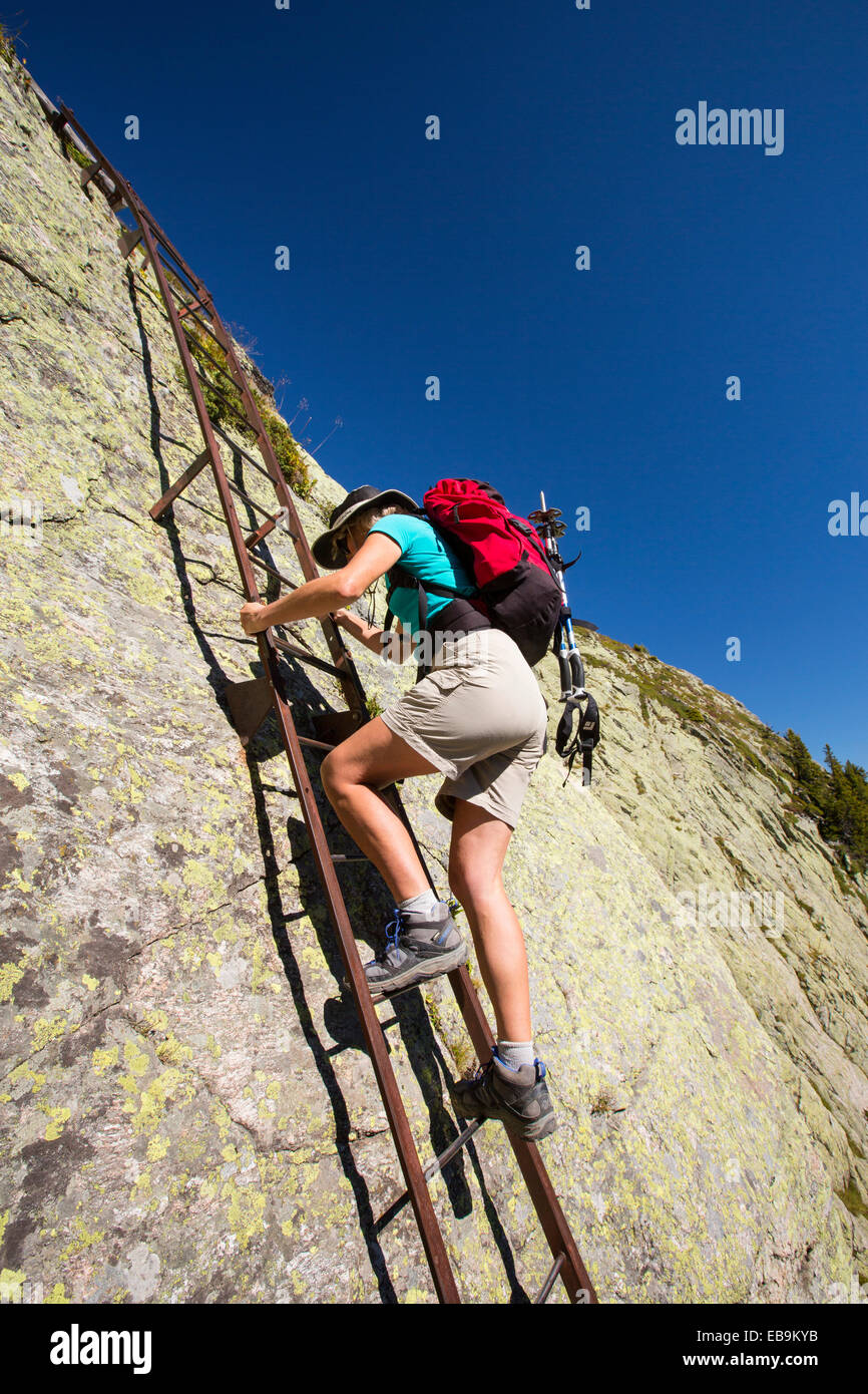 Woman climbing a ladder hires stock photography and images Alamy