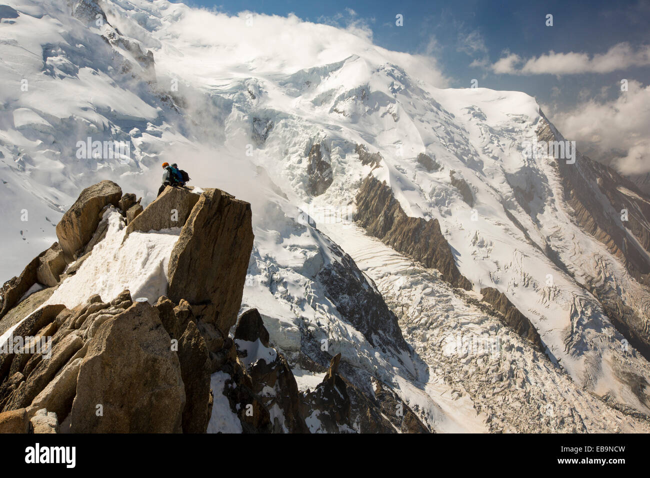 Mont Blanc from the Aiguille Du Midi above Chamonix, France, with climbers on the Cosmiques Arete. Stock Photo