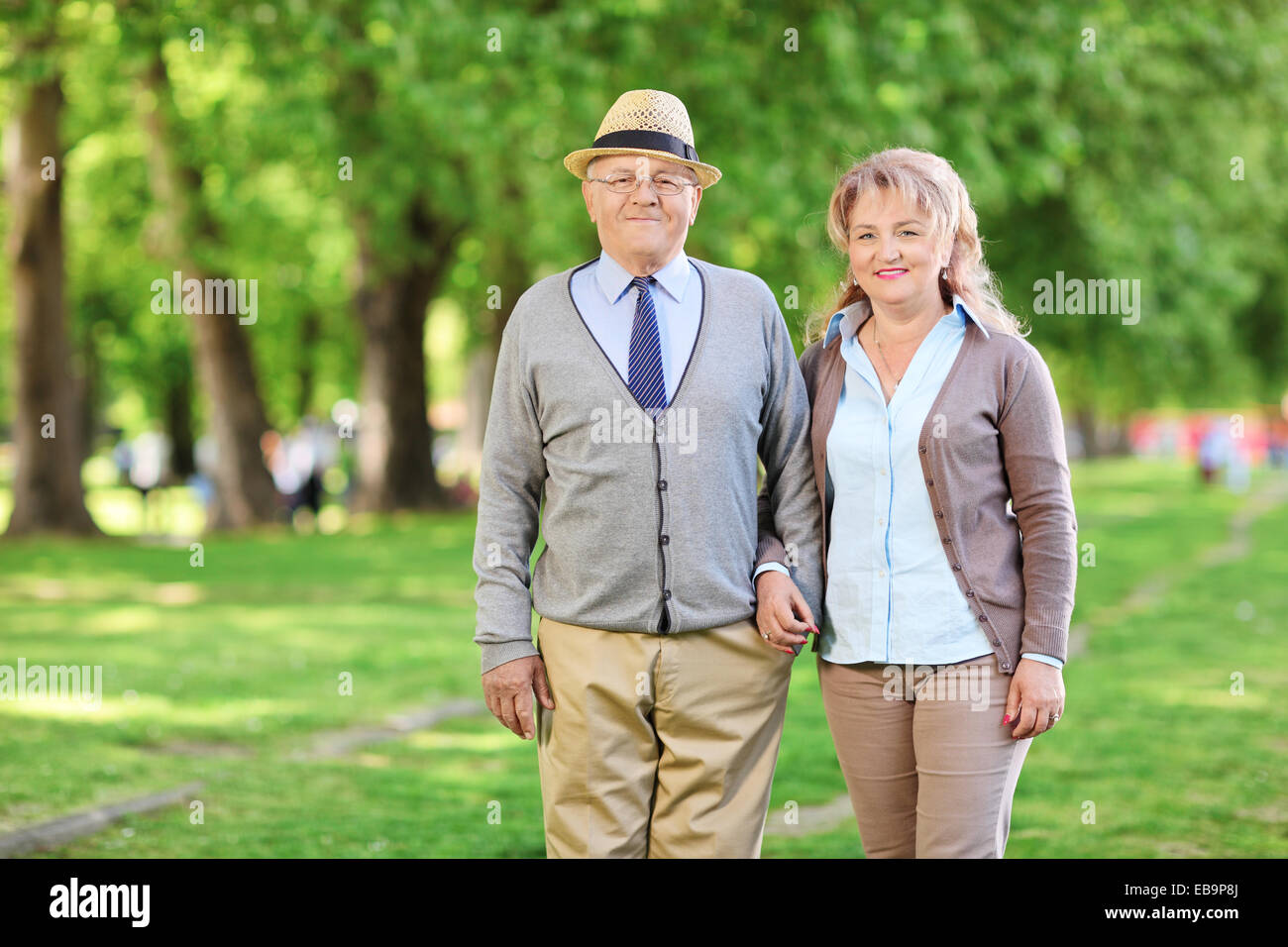 Happy mature couple posing in a park Stock Photo