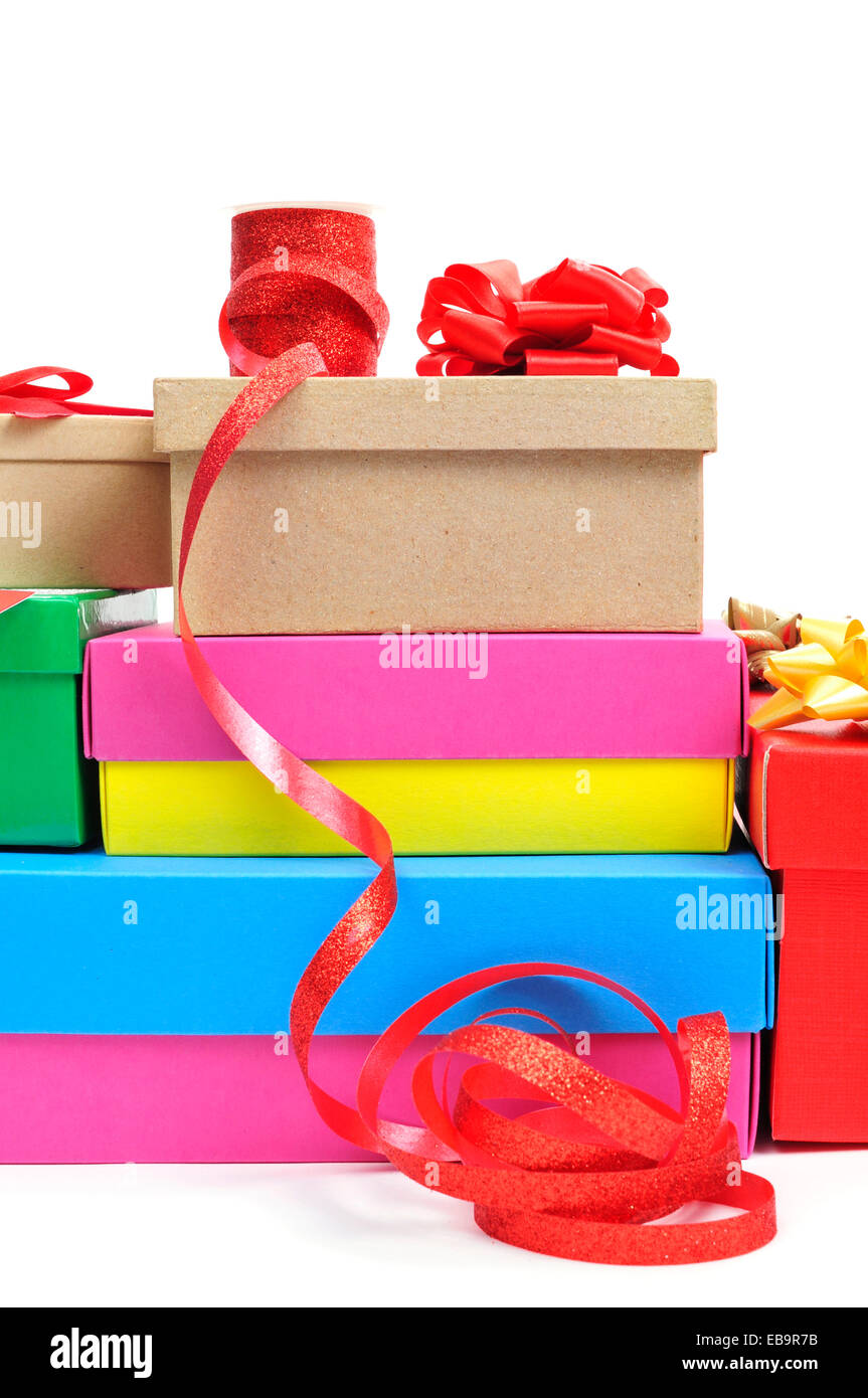 a pile of different boxes, ribbon and ribbon bows of different colors to prepare gifts, on a white background Stock Photo