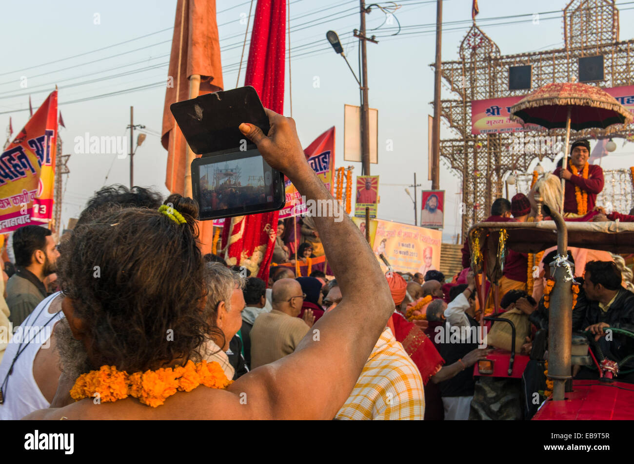 Sadhu, holy man, taking pictures at the Shahi Snan, the royal bath, during Kumbha Mela festival, Allahabad, Uttar Pradesh, India Stock Photo