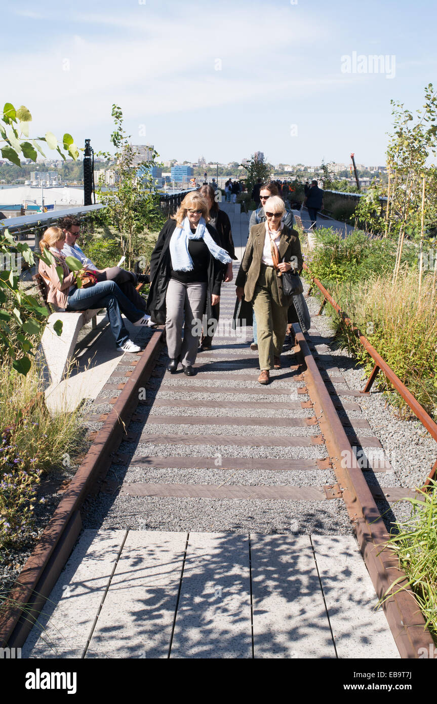Female tourists walking between the tracks along the High Line, New York City, USA Stock Photo