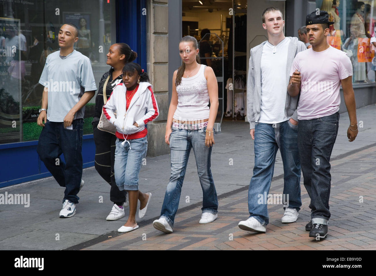 Multiracial group of teenagers walking down a street together, Stock Photo