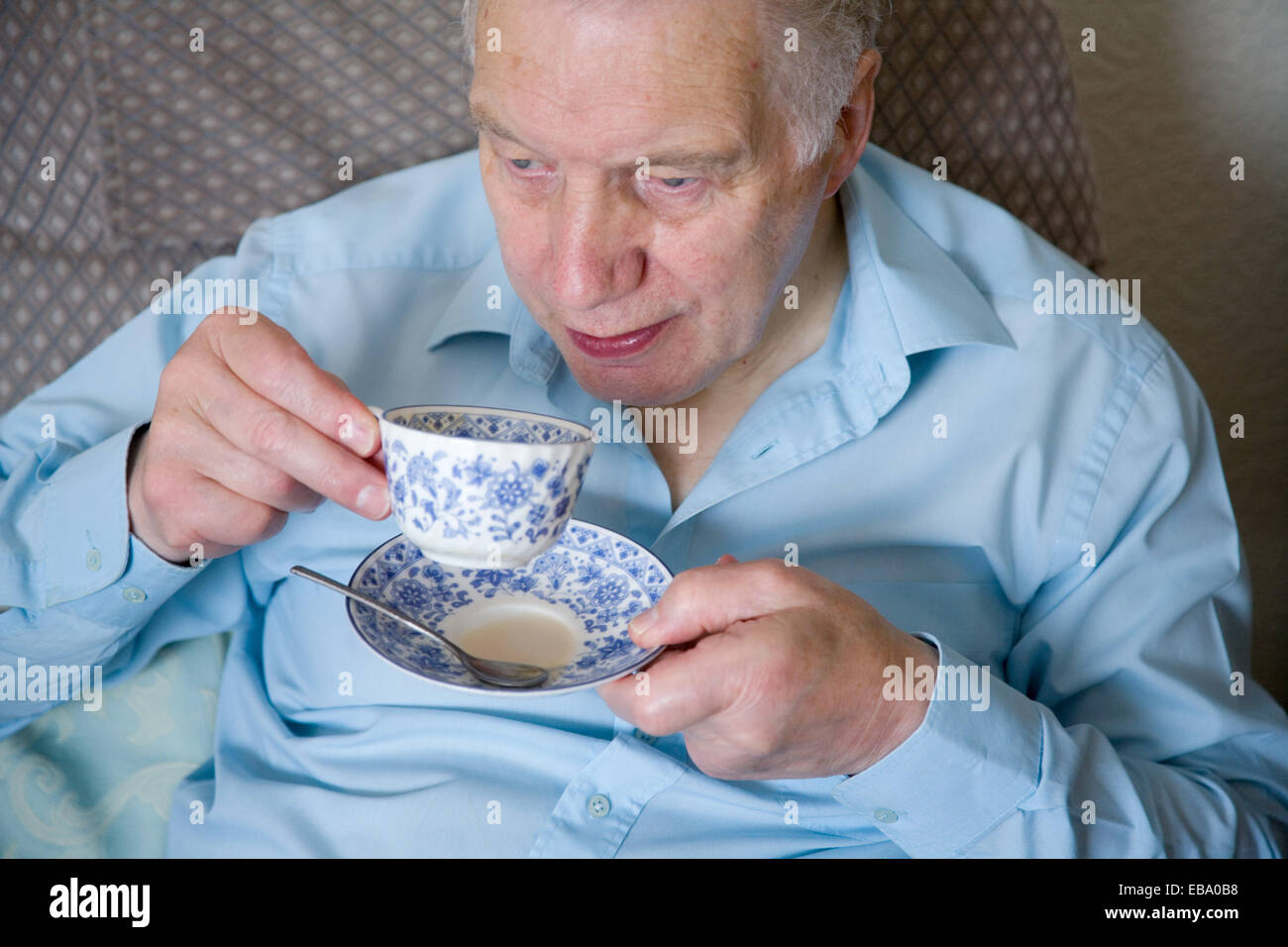 Older man sitting at home drinking a cup of tea Stock Photo Alamy