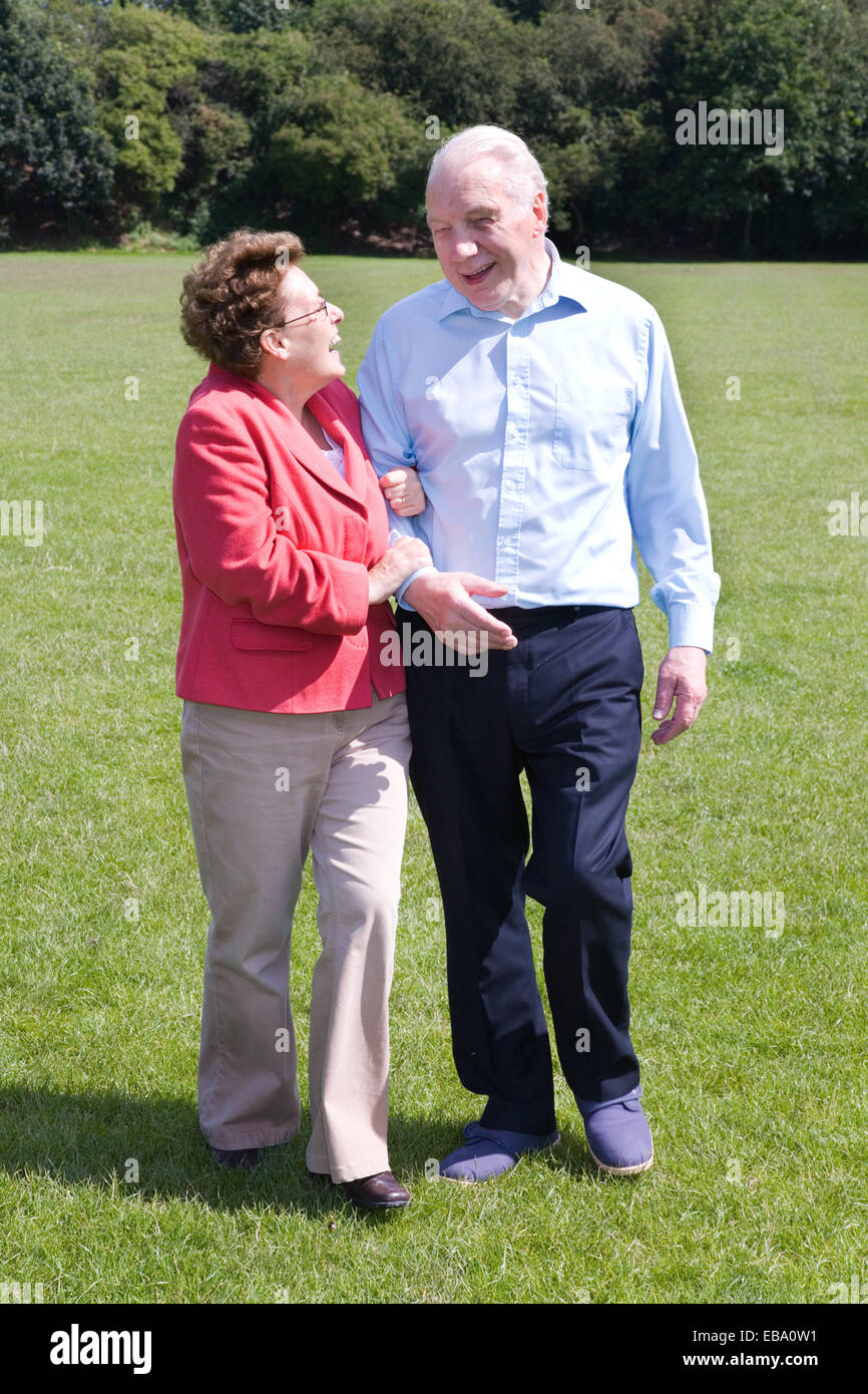 Older couple walking through the park together Stock Photo - Alamy