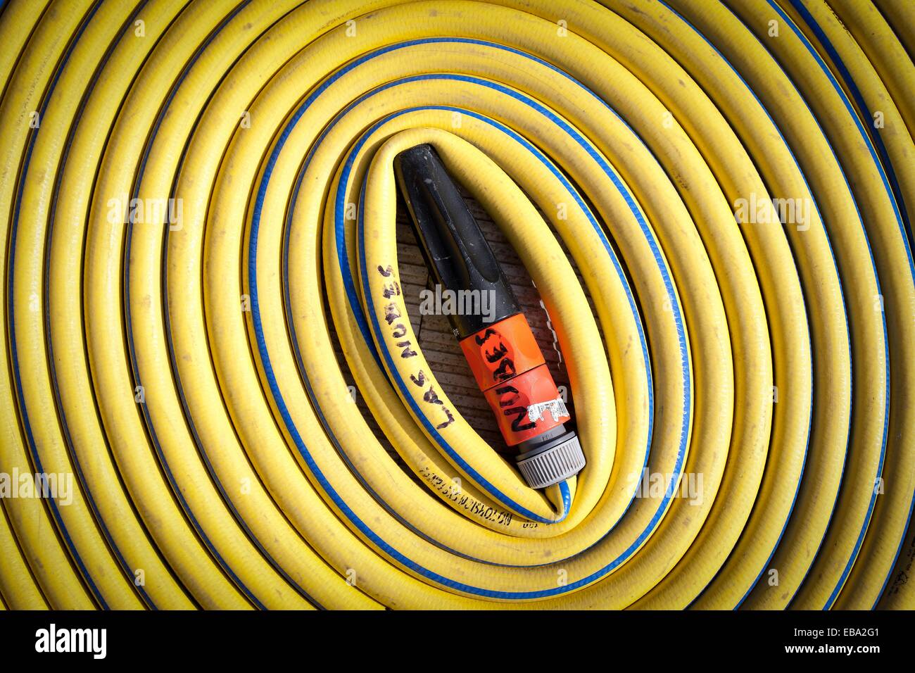 Yellow rubber hose coiled Stock Photo Alamy