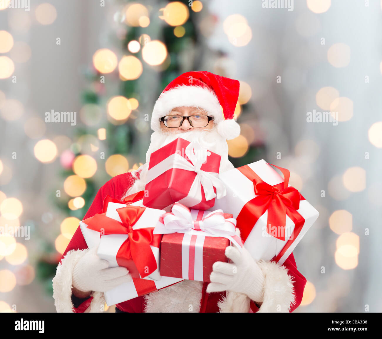 man in costume of santa claus with gift boxes Stock Photo - Alamy