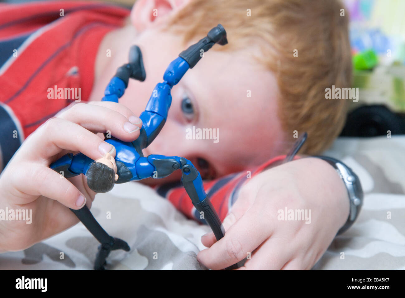 Boy playing with action figure hires stock photography and images Alamy