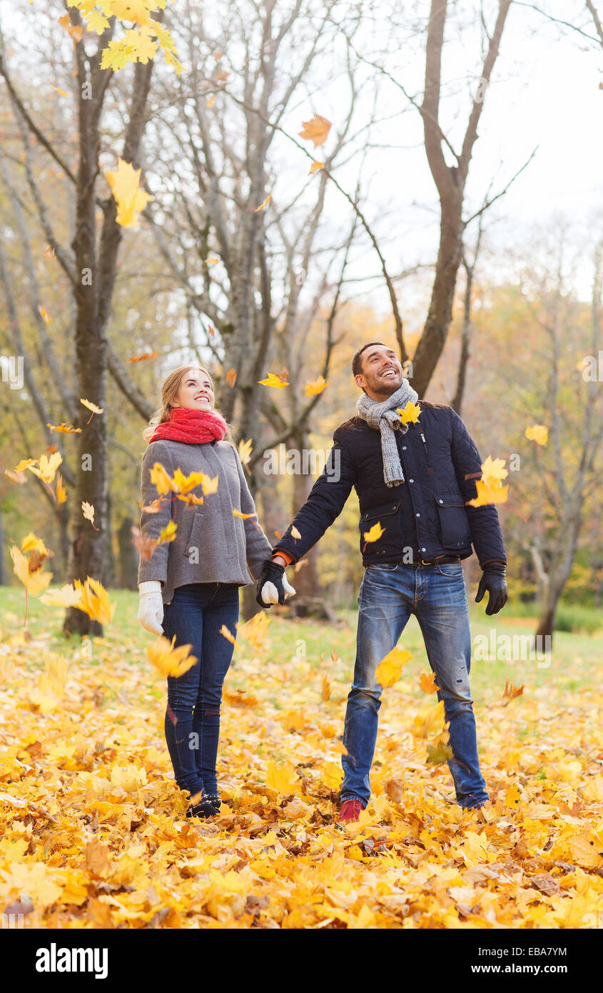 smiling couple having fun in autumn park Stock Photo - Alamy