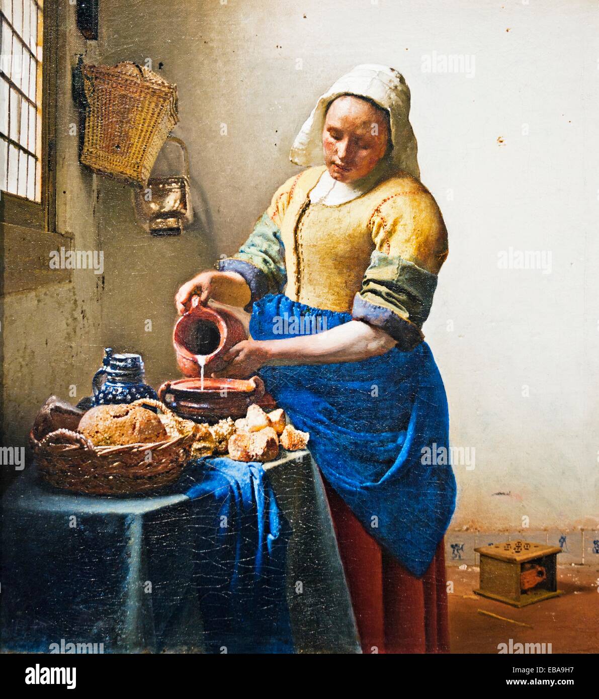 The Milkmaid  De Melkmeid , painting by Johannes Vermeer, Rijksmuseum, Amsterdam, Netherlands. Stock Photo