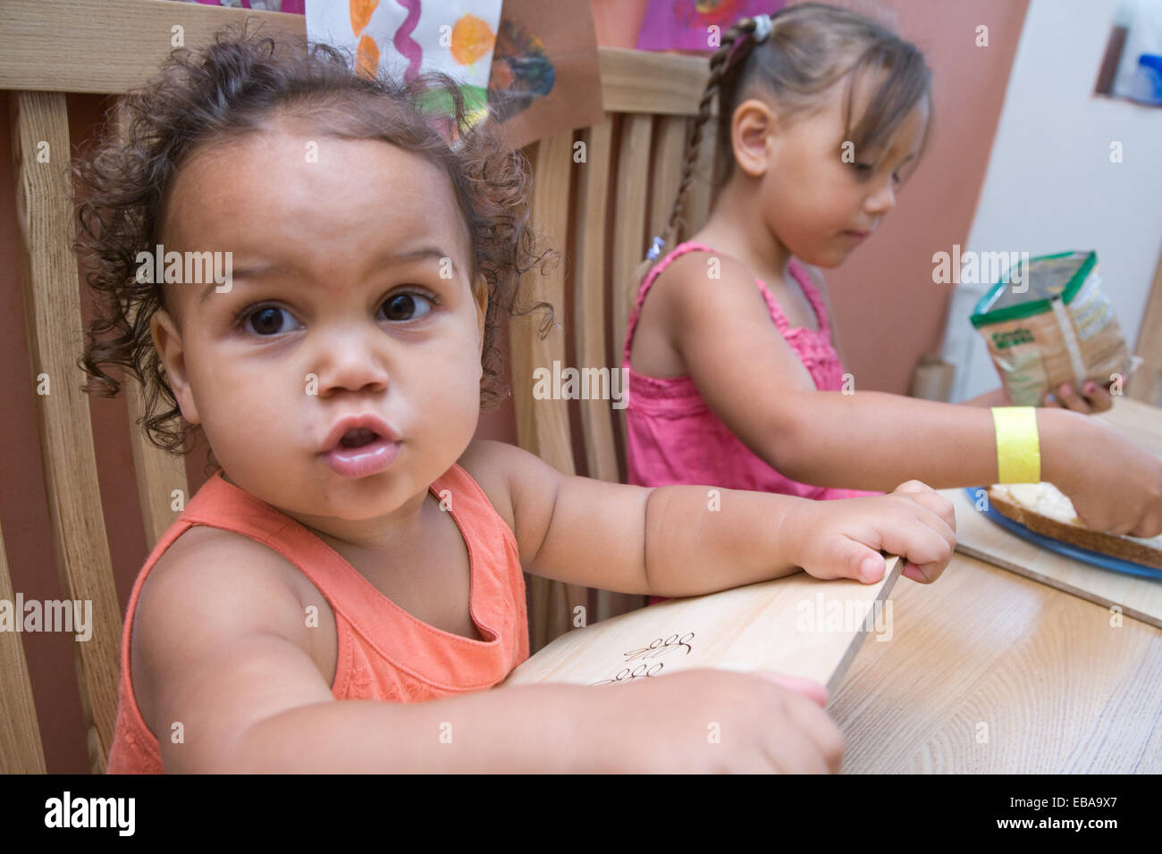 Two sisters sitting at the dinner table Stock Photo - Alamy