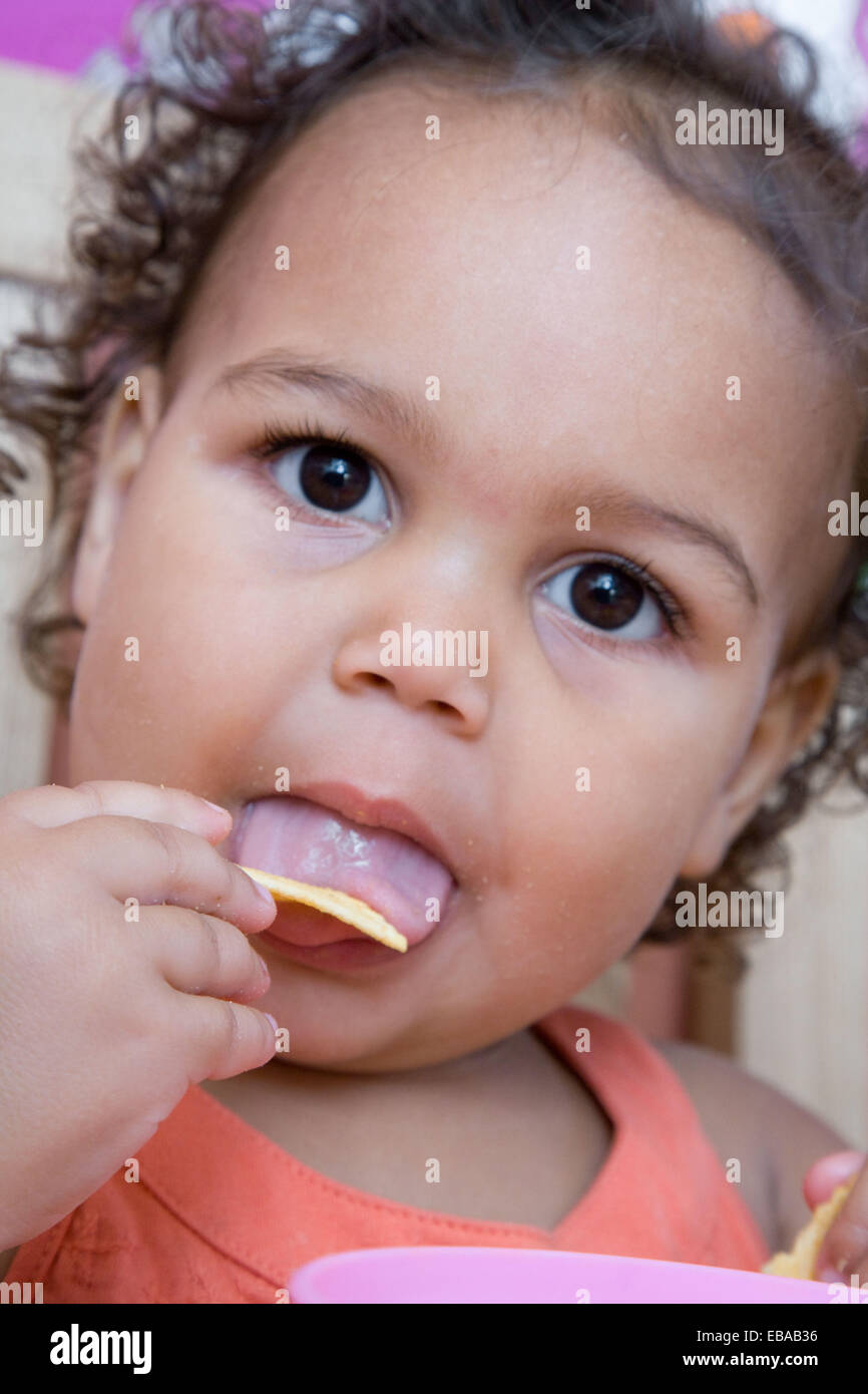 Toddler eating a snack Stock Photo - Alamy