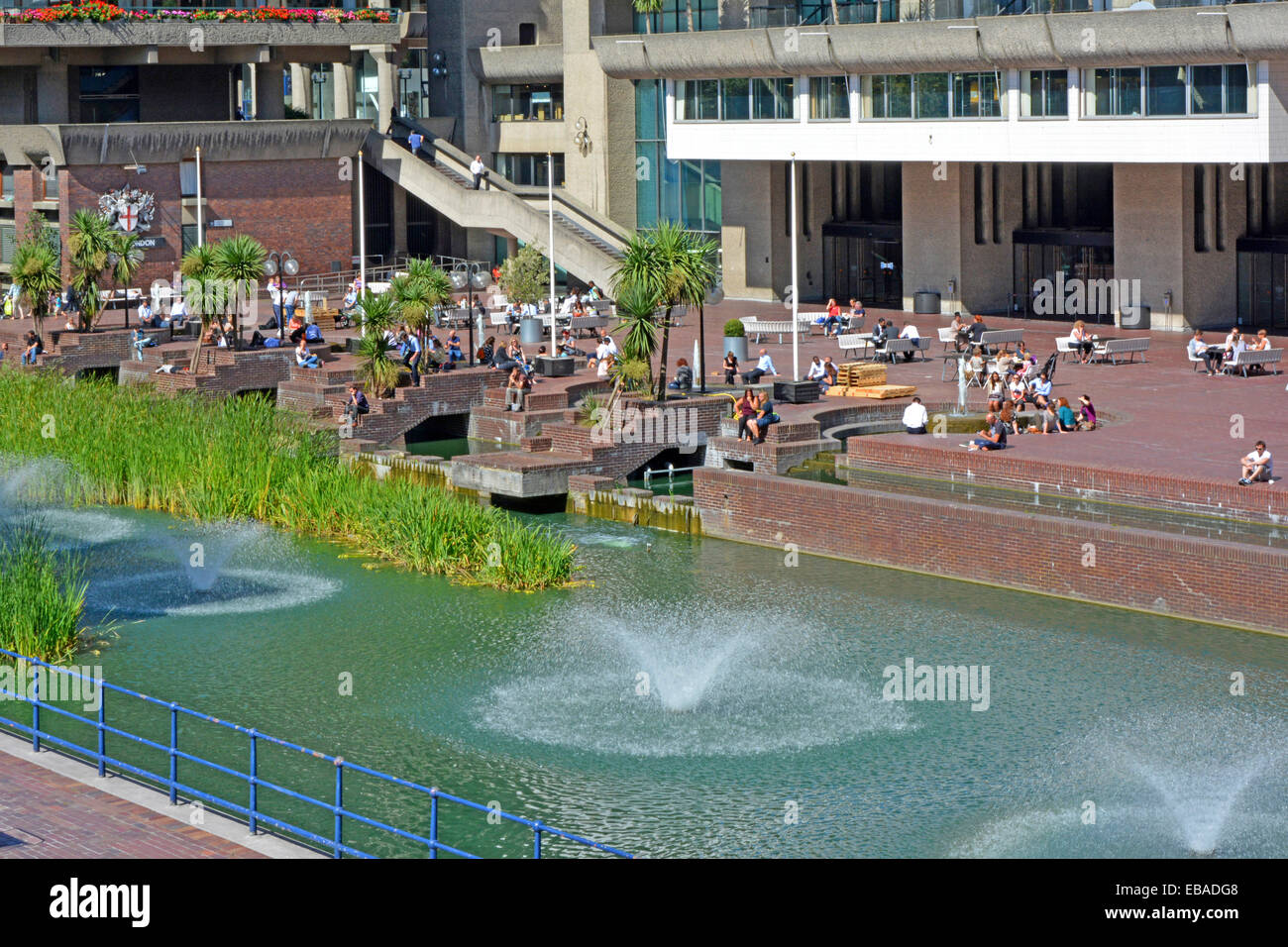 People relaxing at the Barbican Centre terrace and lake with fountains