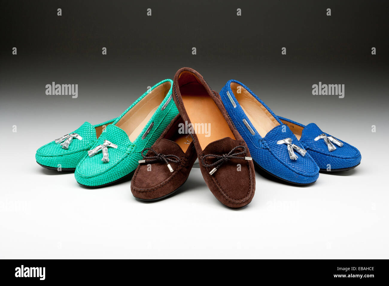 Three pairs of womens loafer shoes on a graduated background. Stock Photo