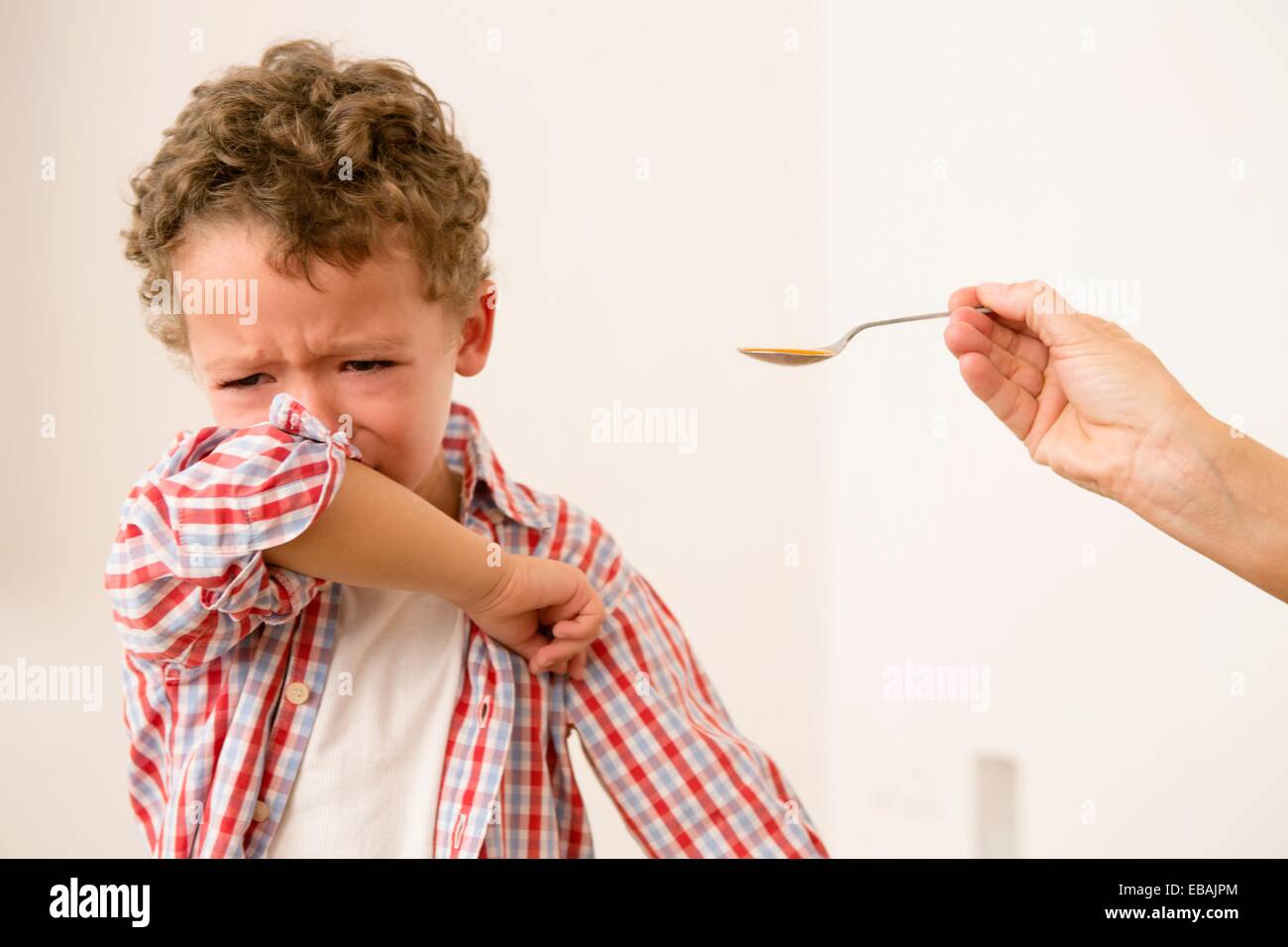 Uunhappy four year old being given medicine Stock Photo Alamy