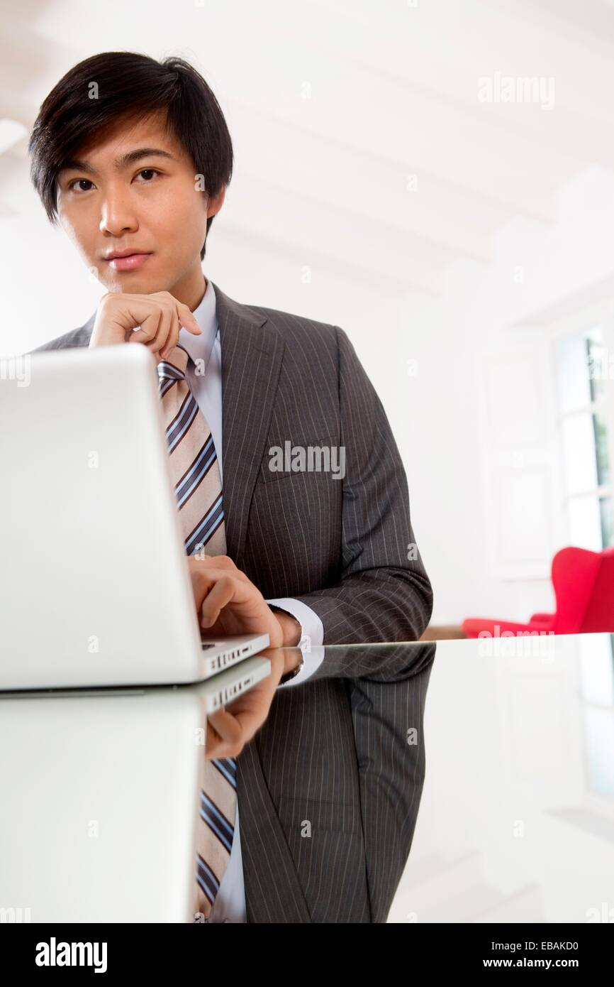 Young Asian man working on his laptop computer Stock Photo - Alamy