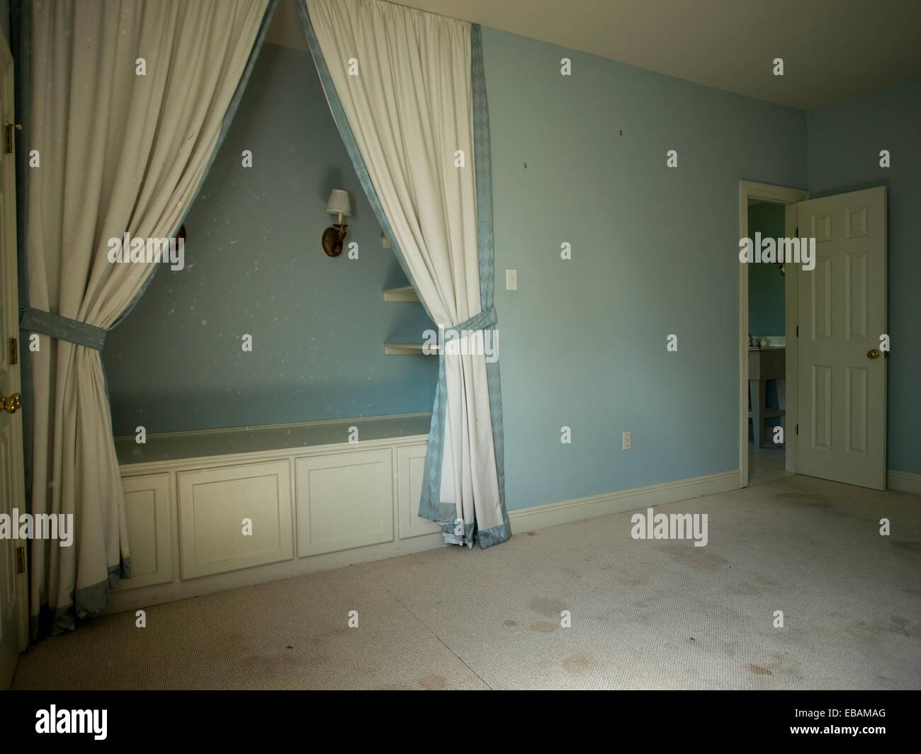 An empty blue bedroom a foreclosed home in Covington, Louisiana