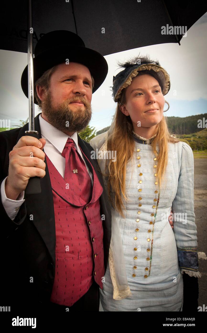 Lady and gentleman in Victorian costume watch performance during Victorian festival, historic precinct, Oamaru, Otago Stock Photo