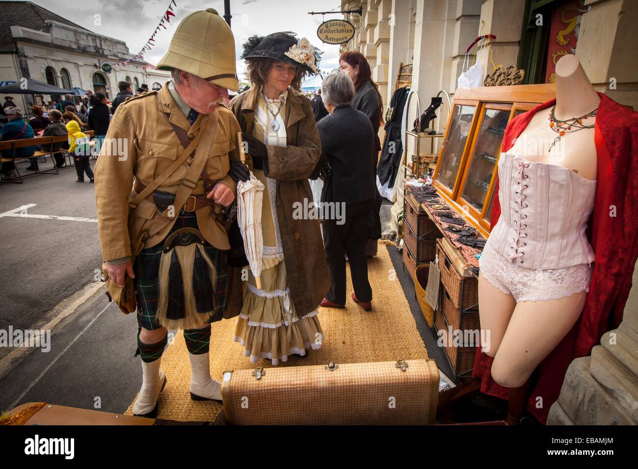 Kilted soldier and lady in Victorian dress browse antique stall, Victorian festival, historic precinct, Oamaru, Otago Stock Photo