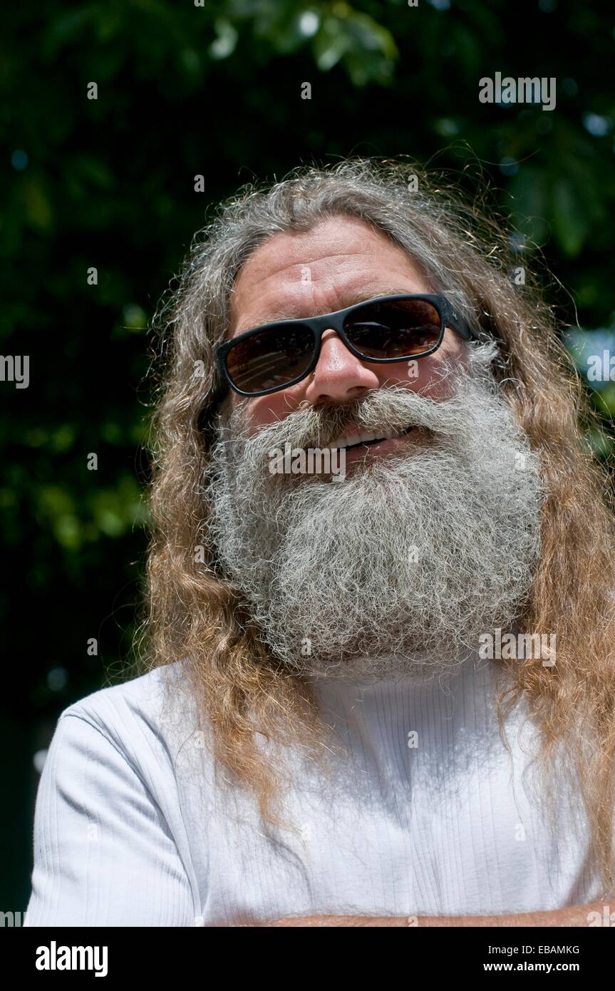 Man with long hair and grey beard outdoors Stock Photo - Alamy