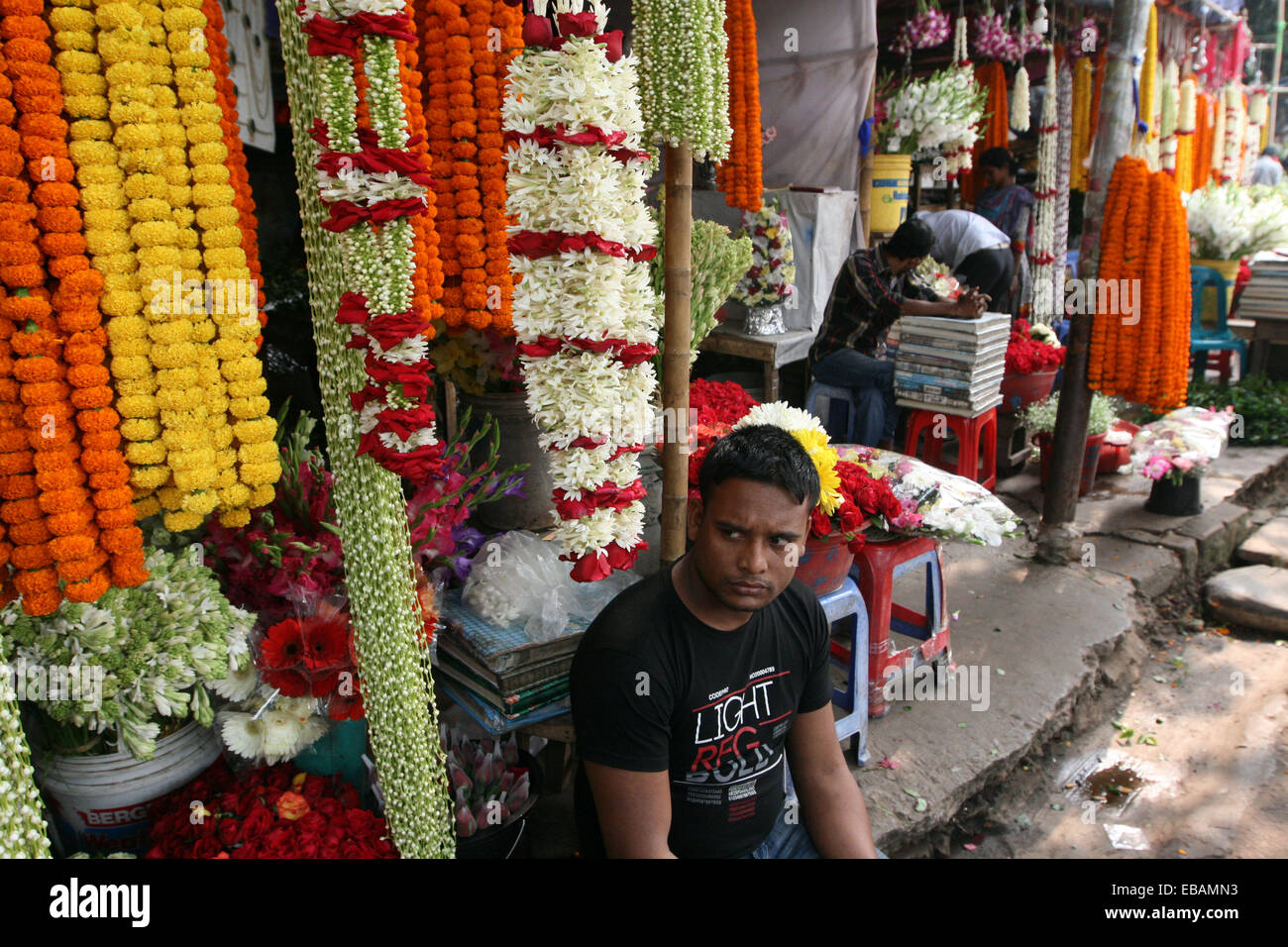 November 2014. Flower vendor at his stall in the flower market in Dhaka