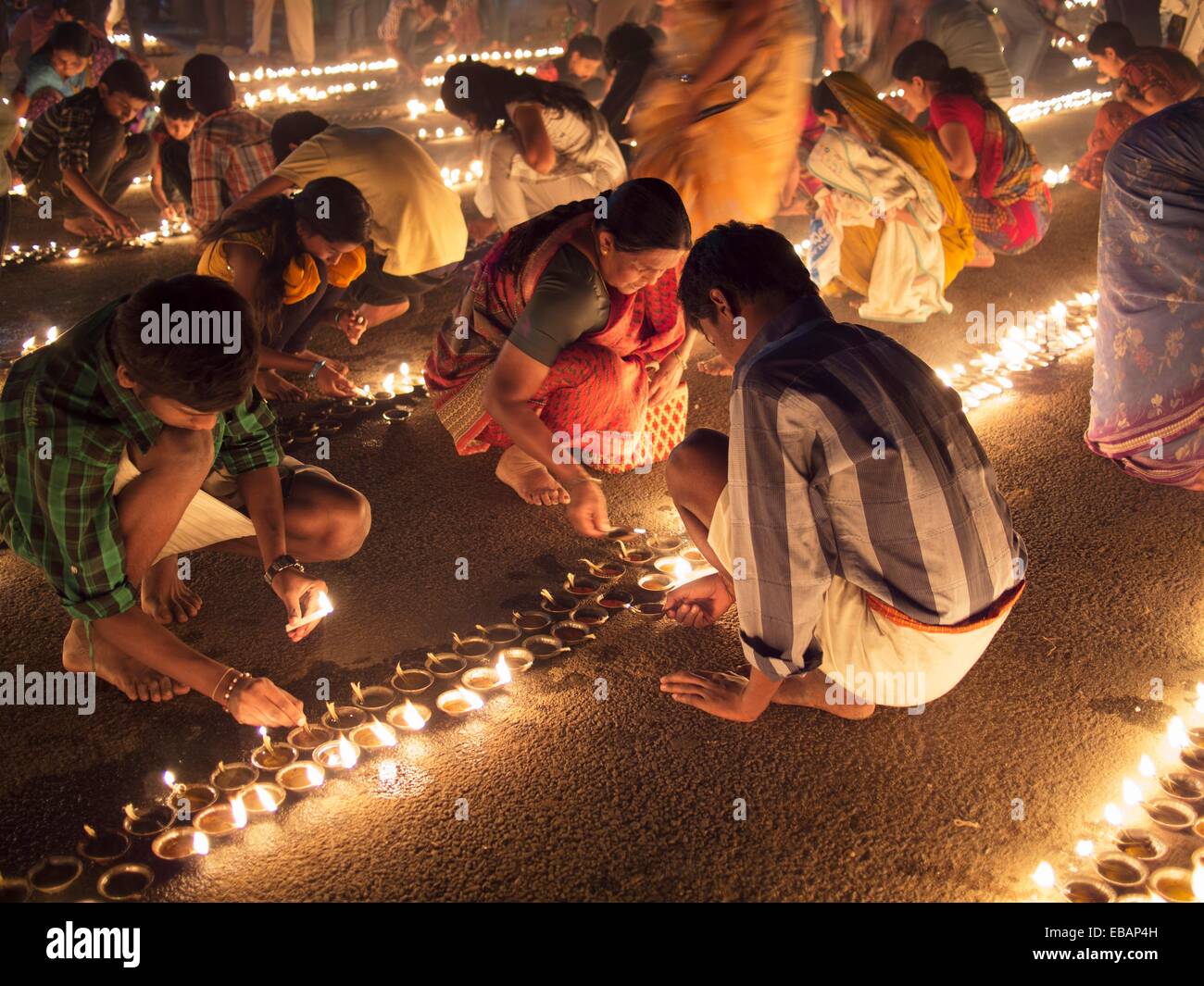 Indians light oil lamps in the street for a Hindu festival in Bangalore
