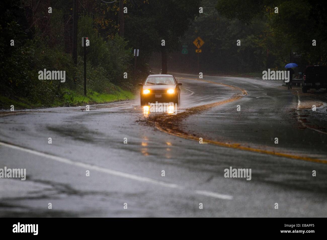 Car Driving with Headlights on in Rain Storm in hills of California near Santa Cruz Stock Photo