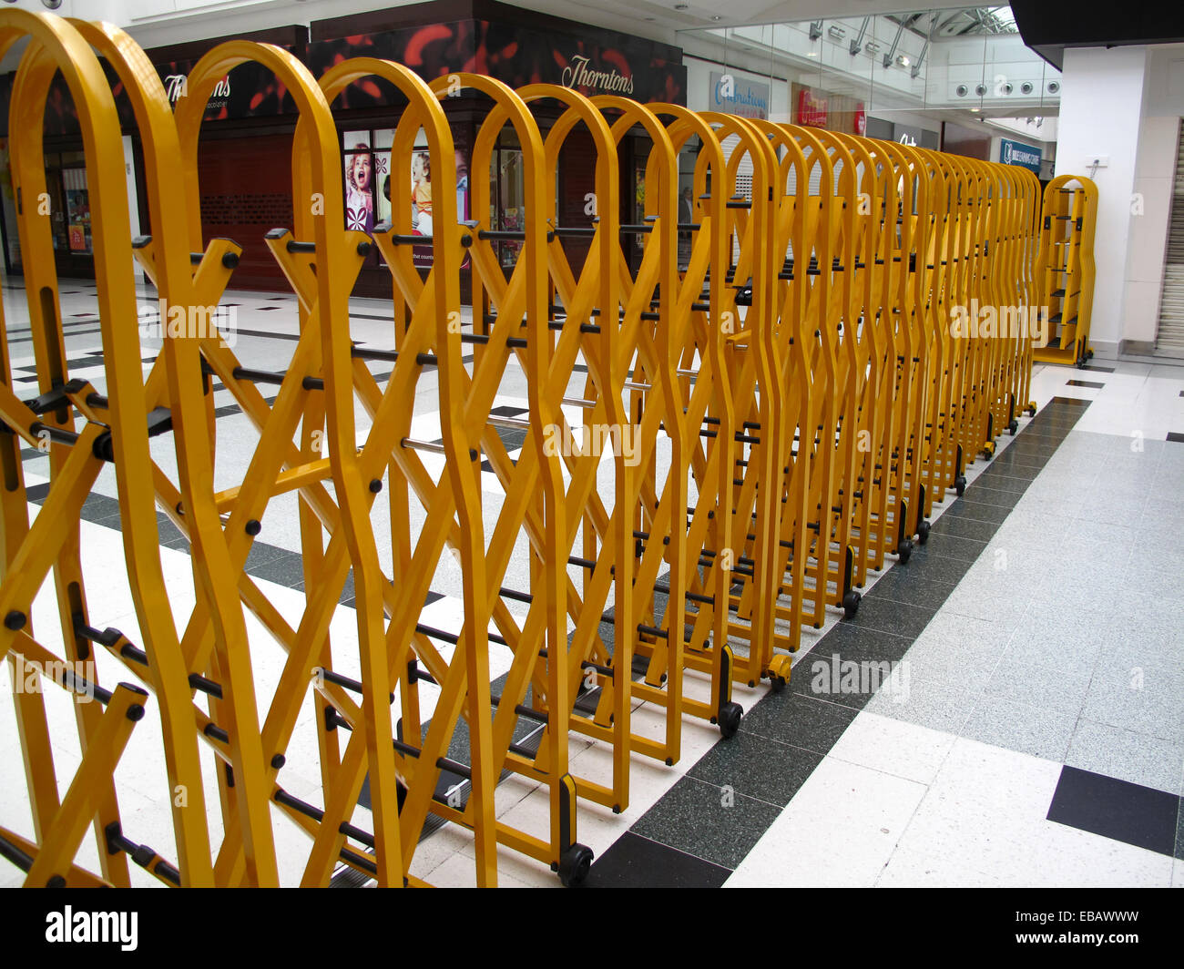 Collapsible security barrier in shopping centre Stock Photo
