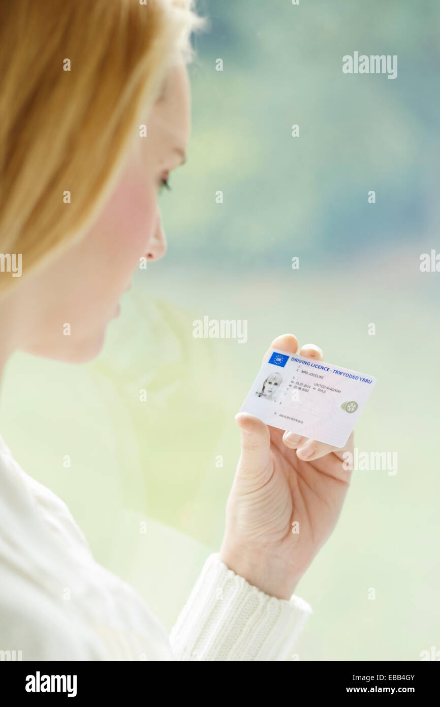Woman holding driving license Stock Photo
