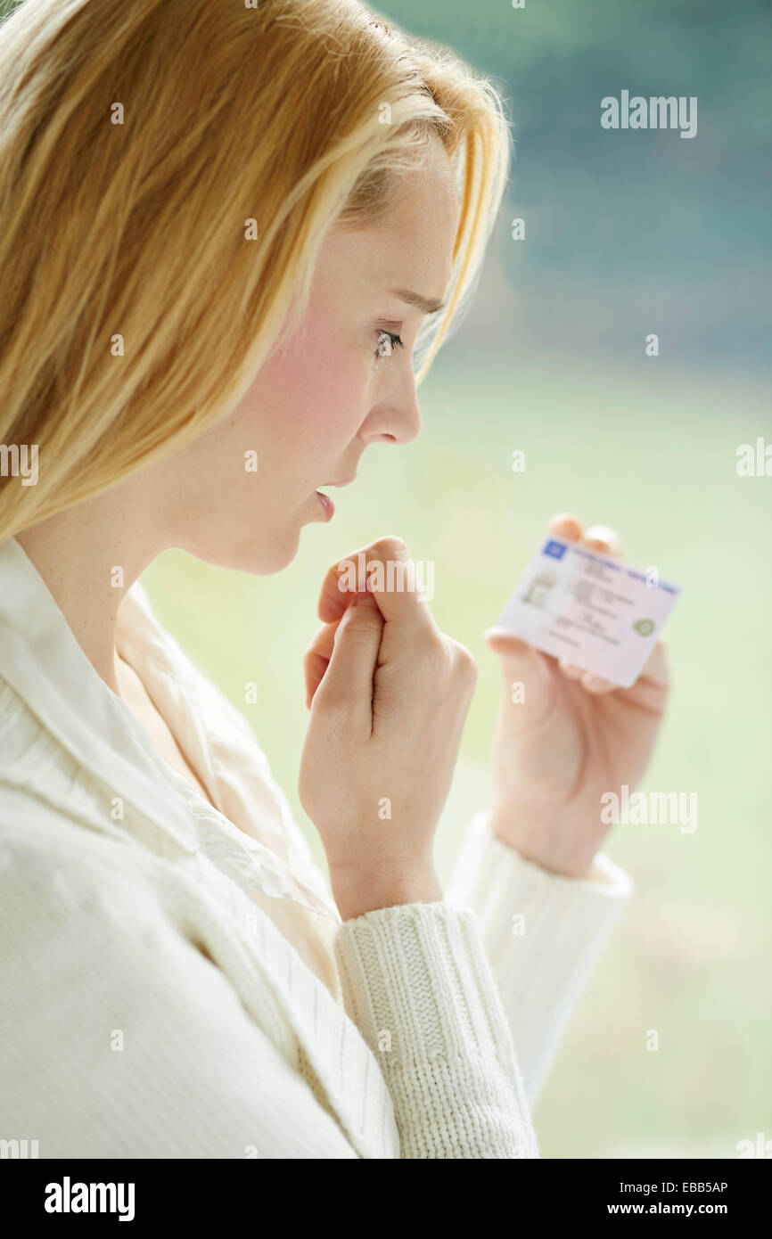 Woman holding driving license Stock Photo