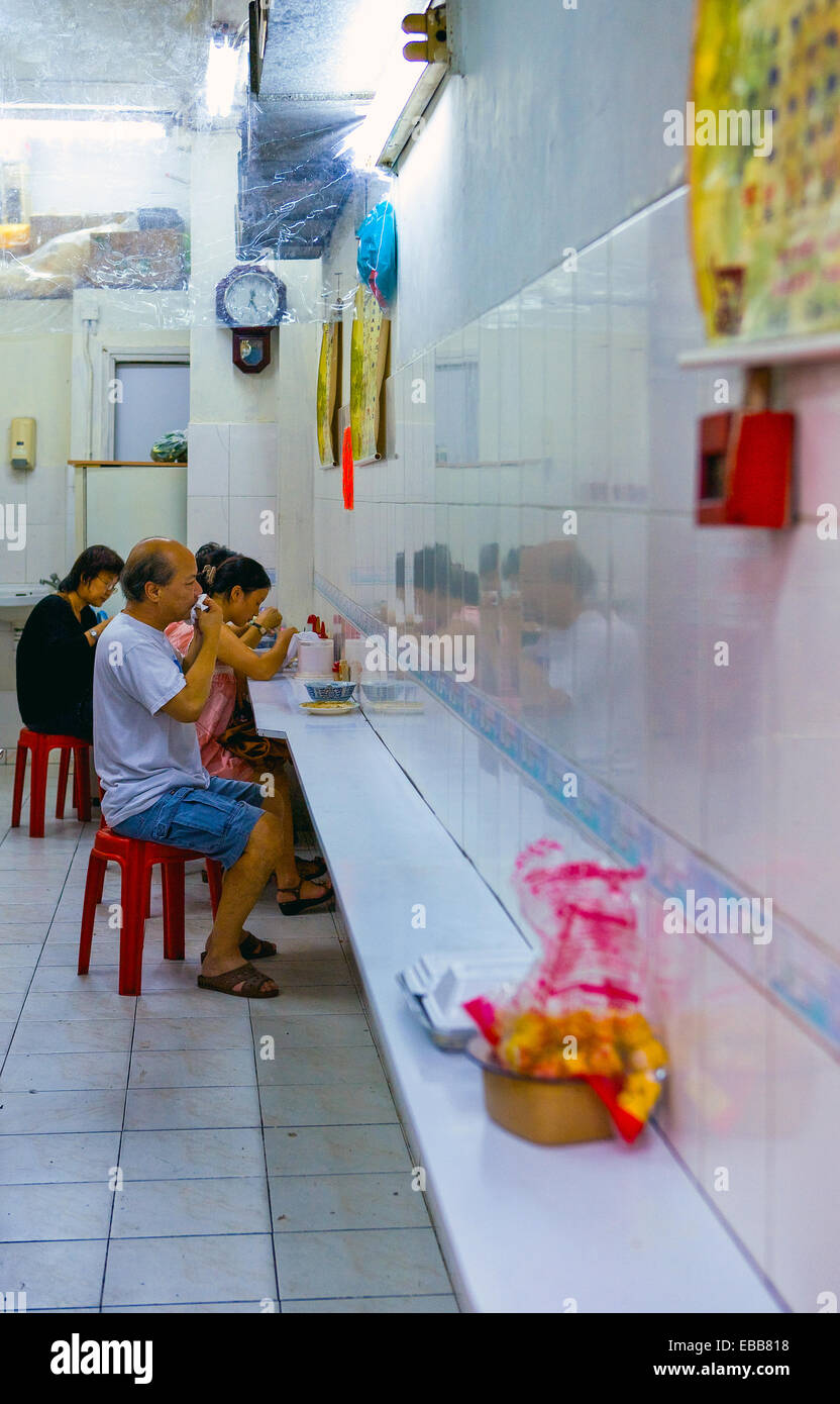 Hong Kong, people in a simple restaurant in the Yu Ma Tei quarter Stock Photo