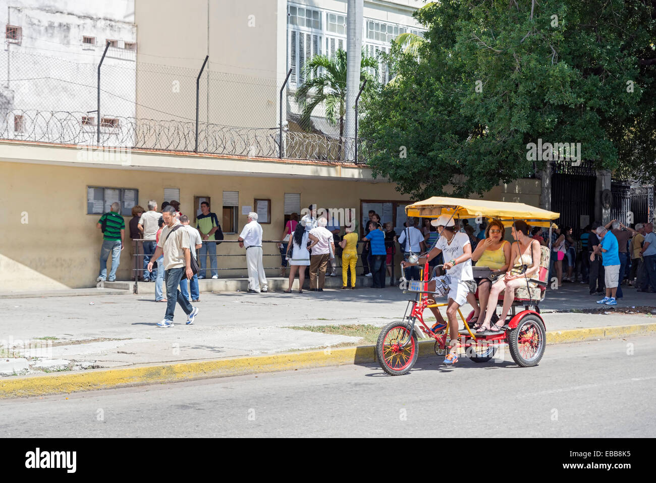 HAVANA , CUBA -  MAY 5, 2014 : People queue at the Spanish embassy to get a visa to leave Cuba, on May 5, 2014 Stock Photo