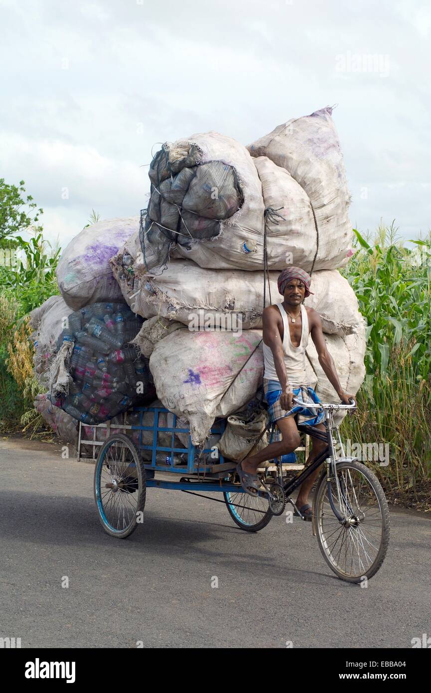 indian man transport big bags filled with plastic bottles on his rickshaw  in dhapa district kolkata west bengal india asia Stock Photo - Alamy
