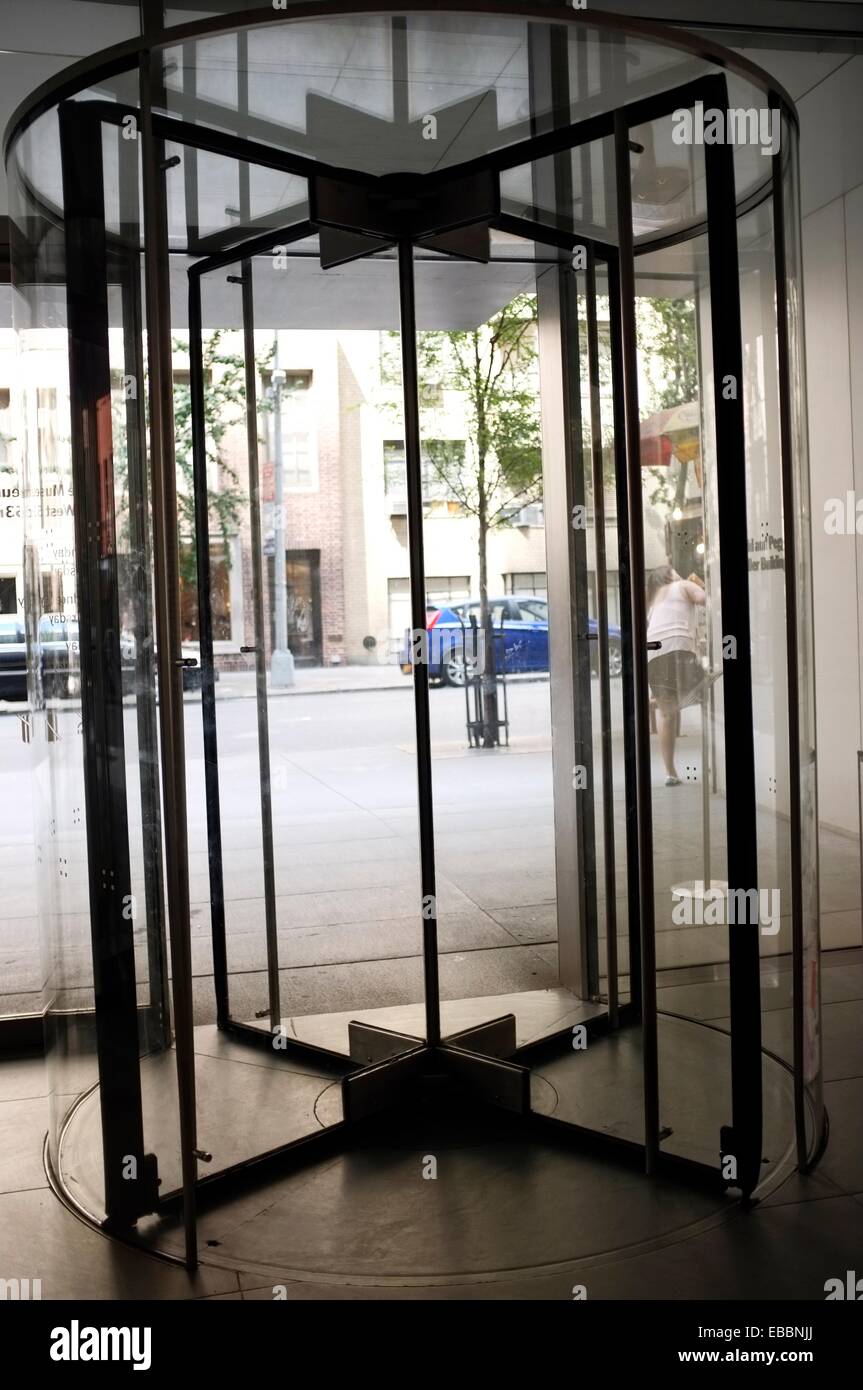 Looking Out Through a Revolving Glass Door at a City Street Stock Photo