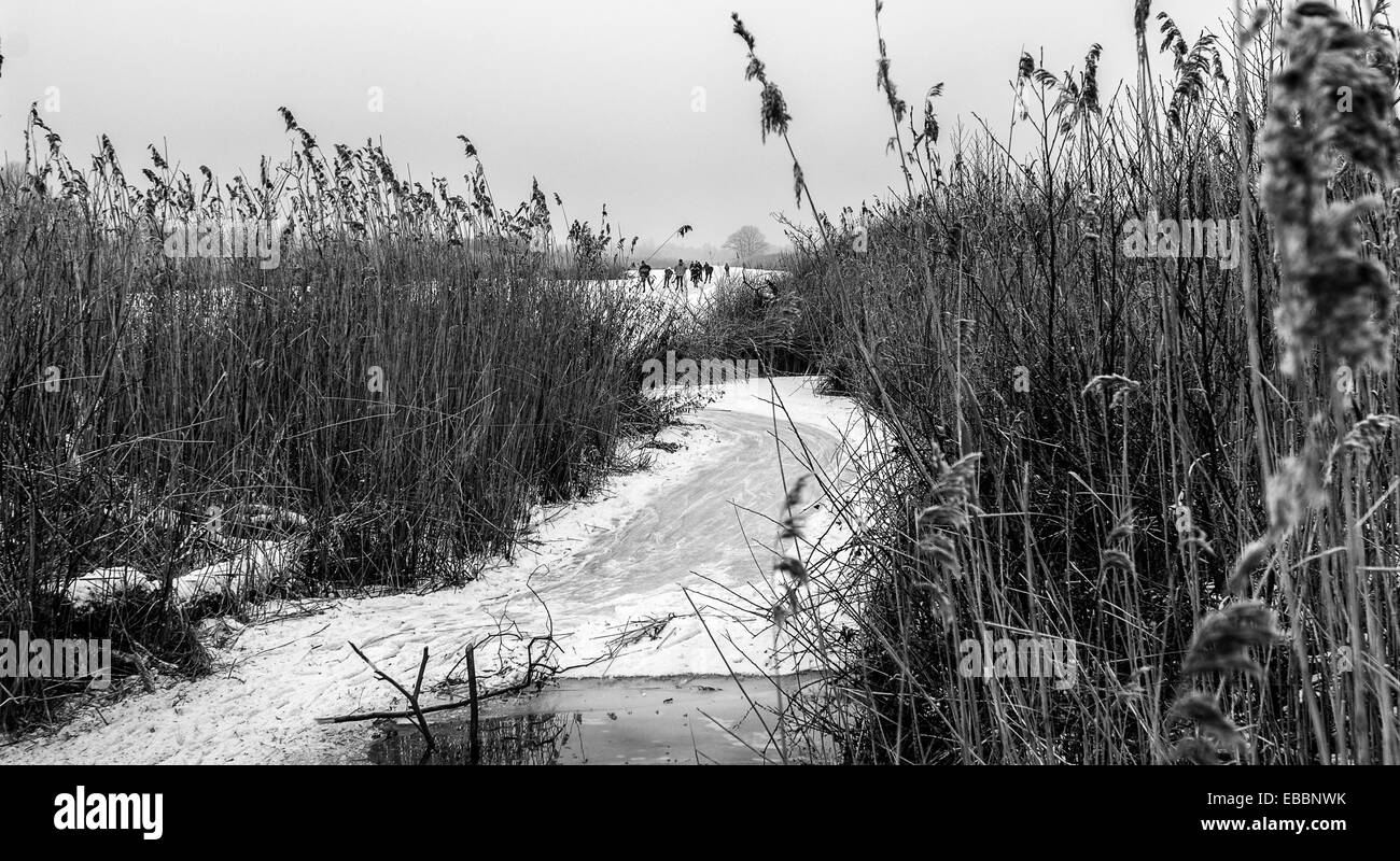 Snowy rural scene with frozen lake/river in Holland Stock Photo