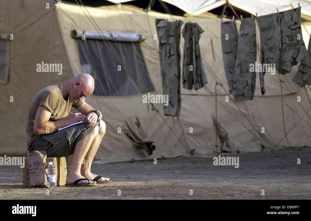 OPERATION IRAQI FREEDOM - Airman Martin Rygula, an air transportation craftsman, takes time to write a letter while deployed to Stock Photo