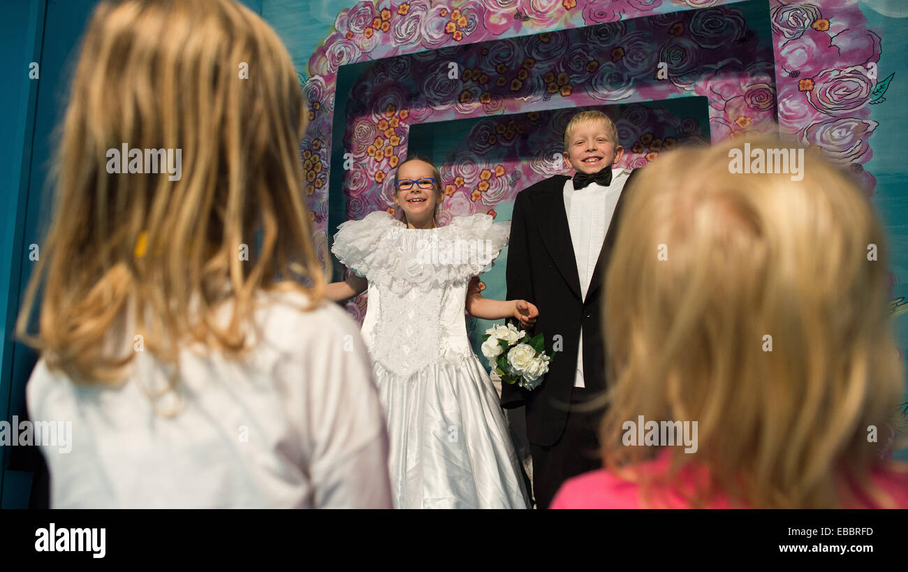 Dresden, Germany. 28th Nov, 2014. Kristin (8 years old, L-R), Victoria and Paul from the 117th Elementary School stand in the station 'Photo Studio' in a station of the new interactive exhibition 'Alles Familie!' (Everything Family) in the hygiene museum in Dresden, Germany, 28 November 2014. In ten family rooms of the interactive exhibition, various lifestyles are on display in which kids grow up from 29 November until 22 February 2015. Photo: ARNO BURGI/dpa/Alamy Live News Stock Photo