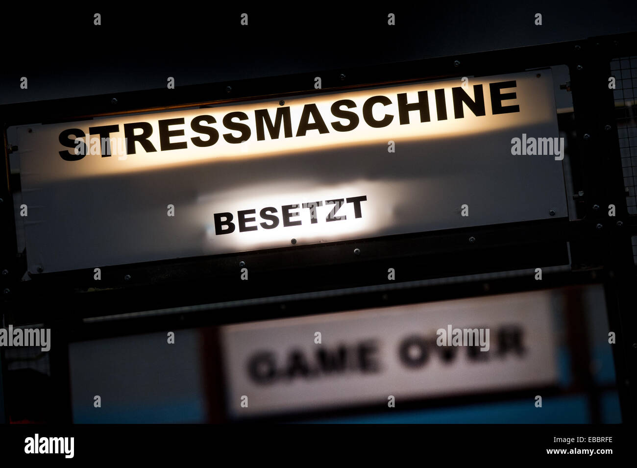 Dresden, Germany. 28th Nov, 2014. 'Stressmaschine, occupied, Game over' is lit up at the a stress machine station of the new interactive exhibition 'Alles Familie!' (Everything Family) in the hygiene museum in Dresden, Germany, 28 November 2014. In ten family rooms of the interactive exhibition, various lifestyles are on display in which kids grow up from 29 November until 22 February 2015. Photo: ARNO BURGI/dpa/Alamy Live News Stock Photo