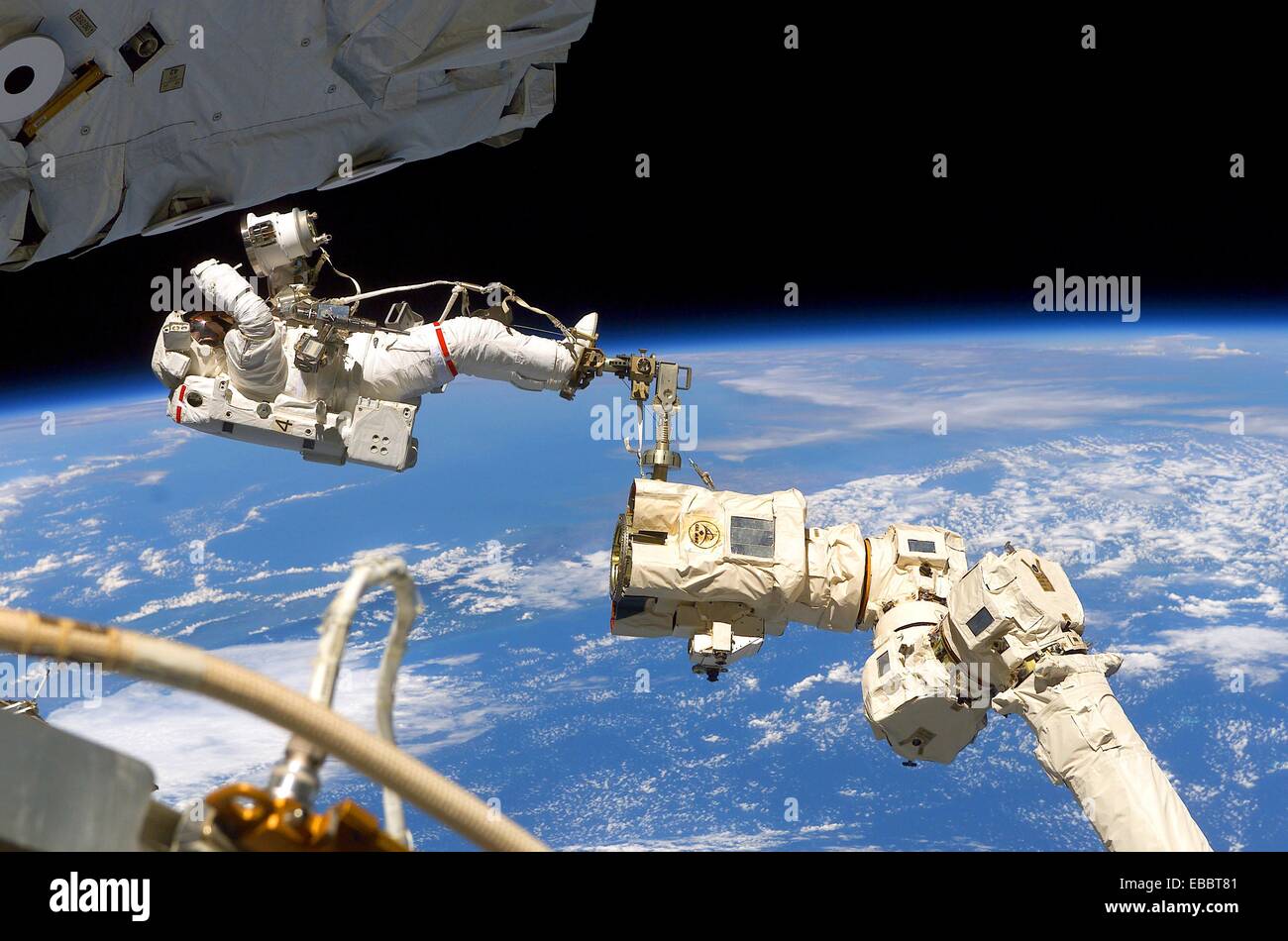 16 April 2002 --- Astronaut Jerry L  Ross, STS-110 mission specialist, anchored to the mobile foot restraint at the end of the Stock Photo