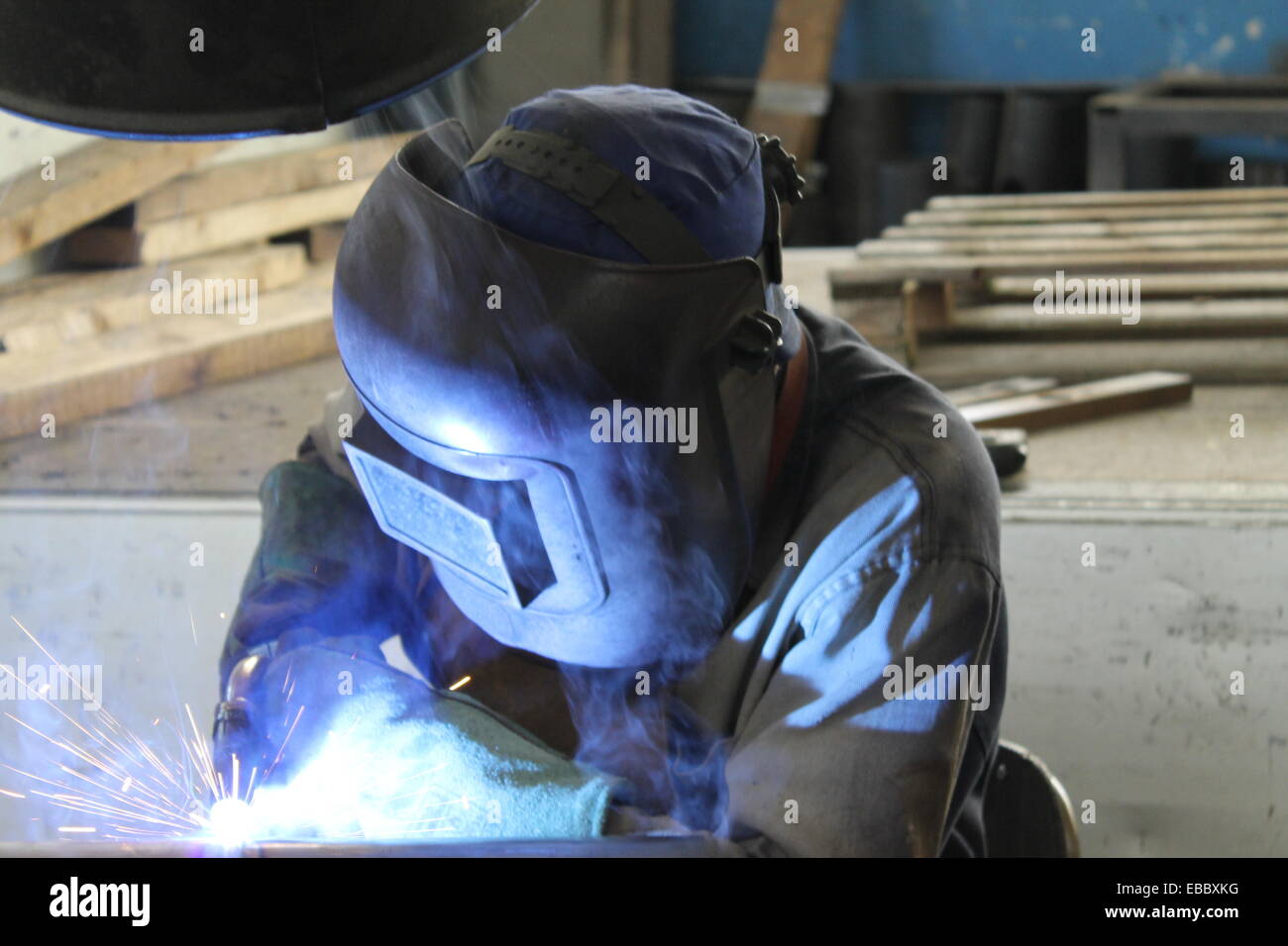 Industrial welder welding on steel in factory Stock Photo