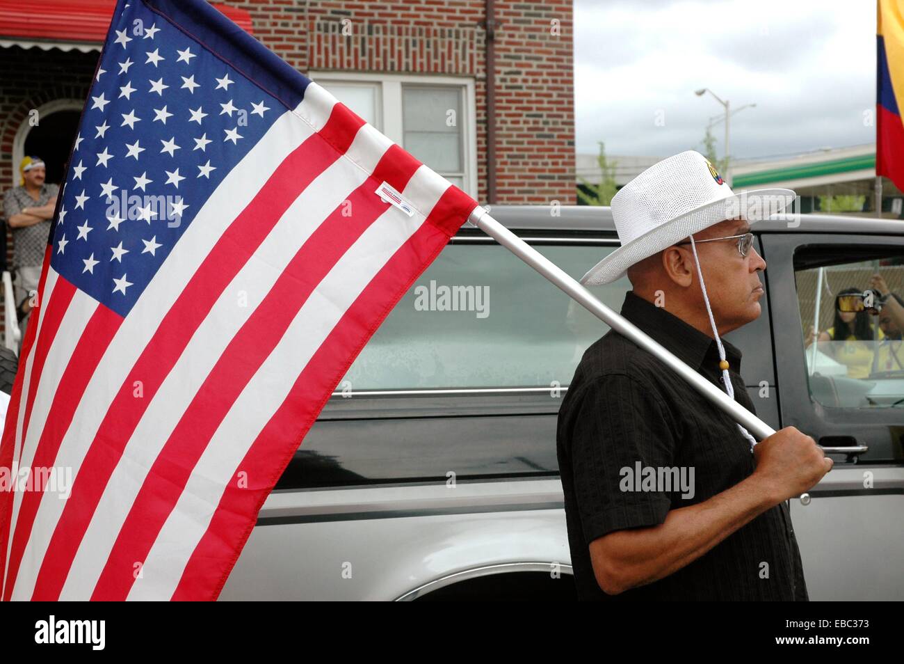 New York City man with the US flag at the annual July Colombian Day