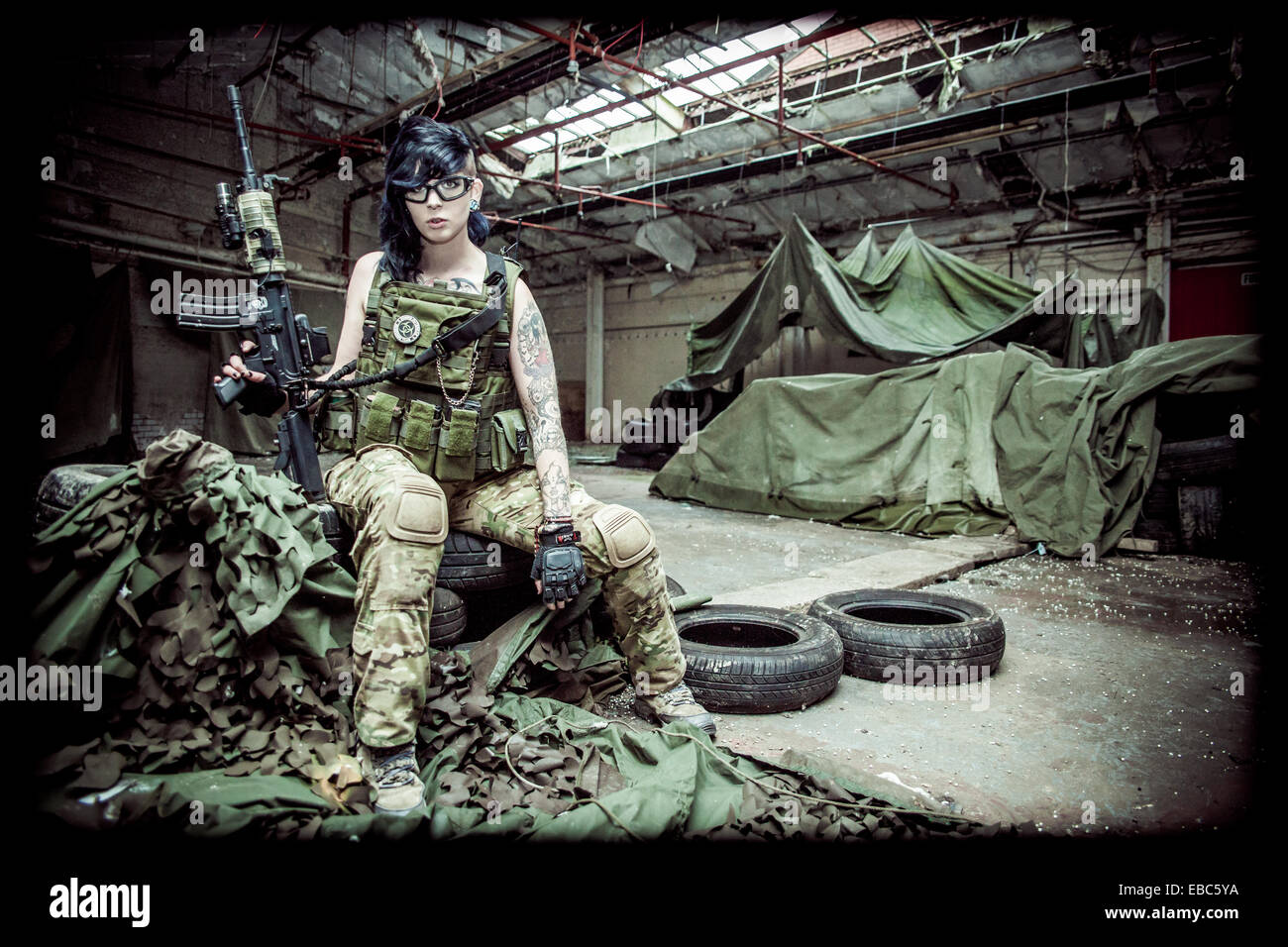 A young female dressed in protective safety clothing for airsoft games