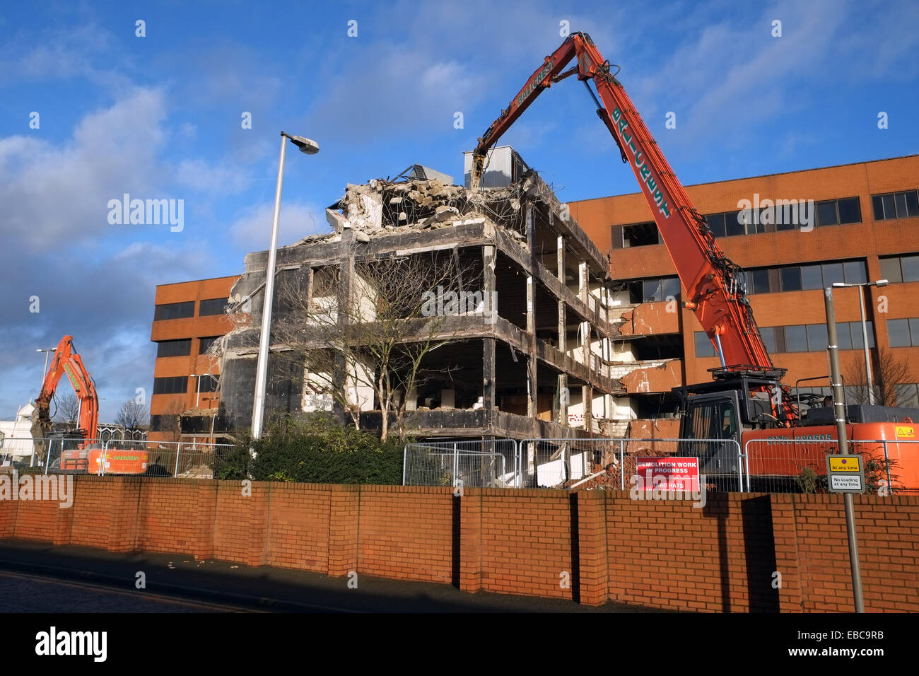 Demolition - machines tear down a building near Heathrow Airport, UK. Stock Photo