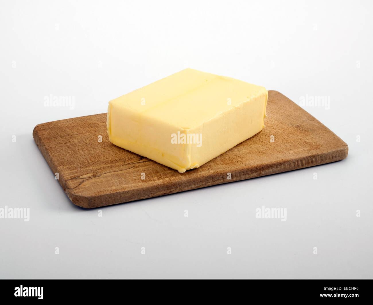 Butter on wooden chopping board Stock Photo