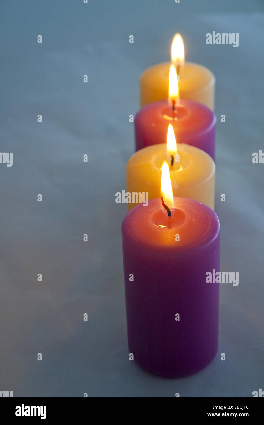 Four lit up candles Stock Photo Alamy