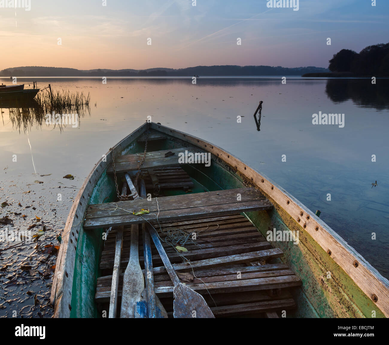 beautiful landscape of lake shore with old boat Stock Photo - Alamy