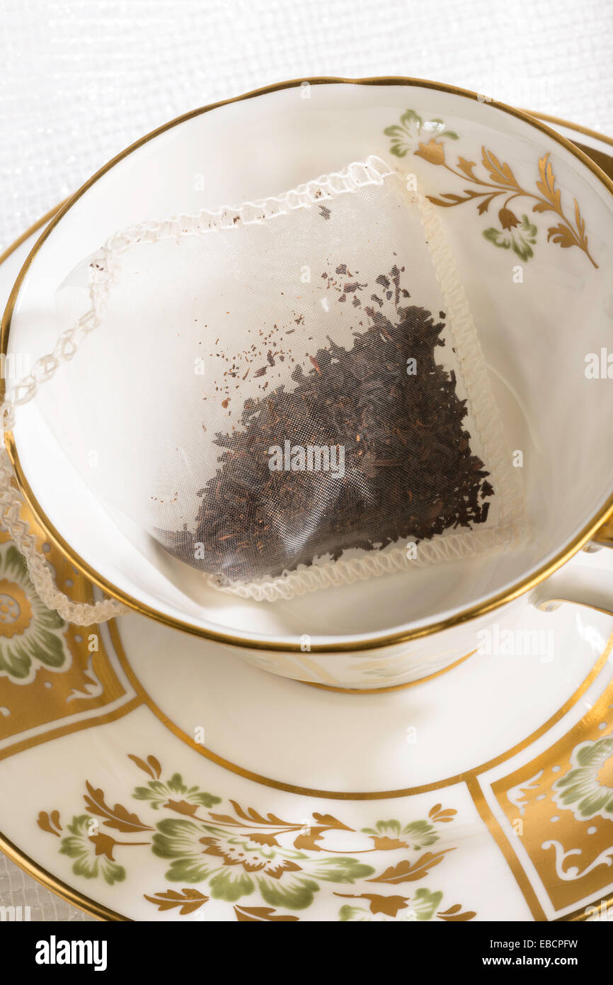 Silk Teabag in China Cup and Saucer Stock Photo Alamy