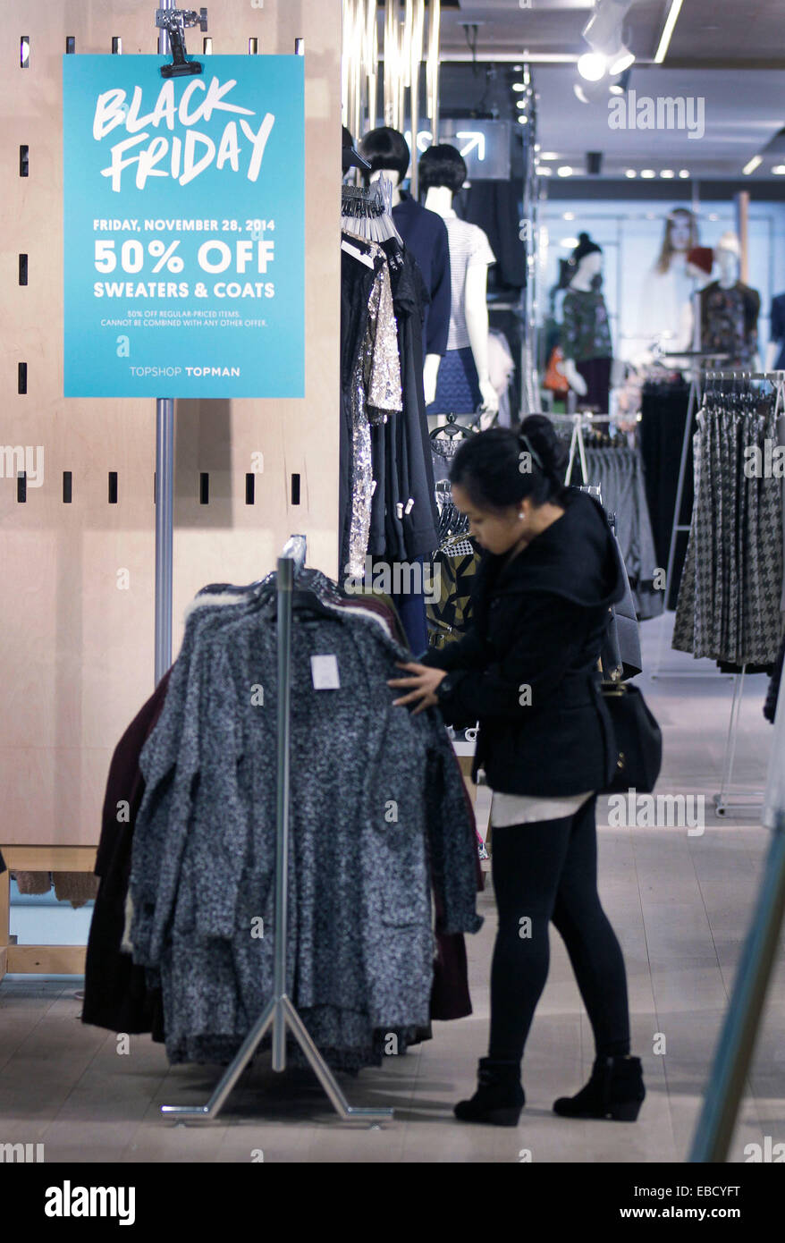 A woman looks for discount coats during the Black Friday event at a shop in  Vancouver, Canada, Nov. 28, 2014. Black Friday sales has become one of the  most important day to