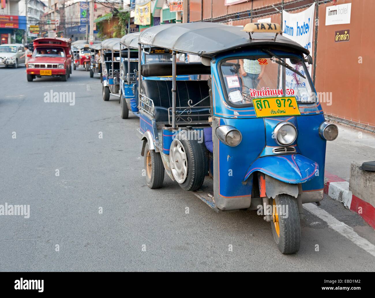 City Street with Tuk Tuks or traditional taxis near Thanon Changklan Chiang Mai Thailand Stock Photo