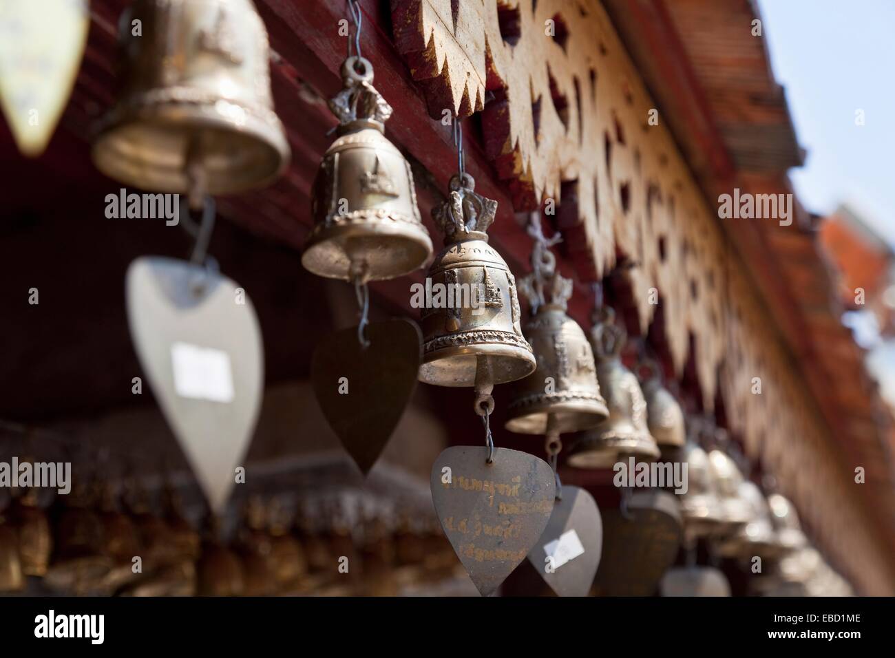 Row of small prayer bells bearing personal messages, Wat Phrathat Doi Suthep, Chiang Mai Province, Thailand Stock Photo